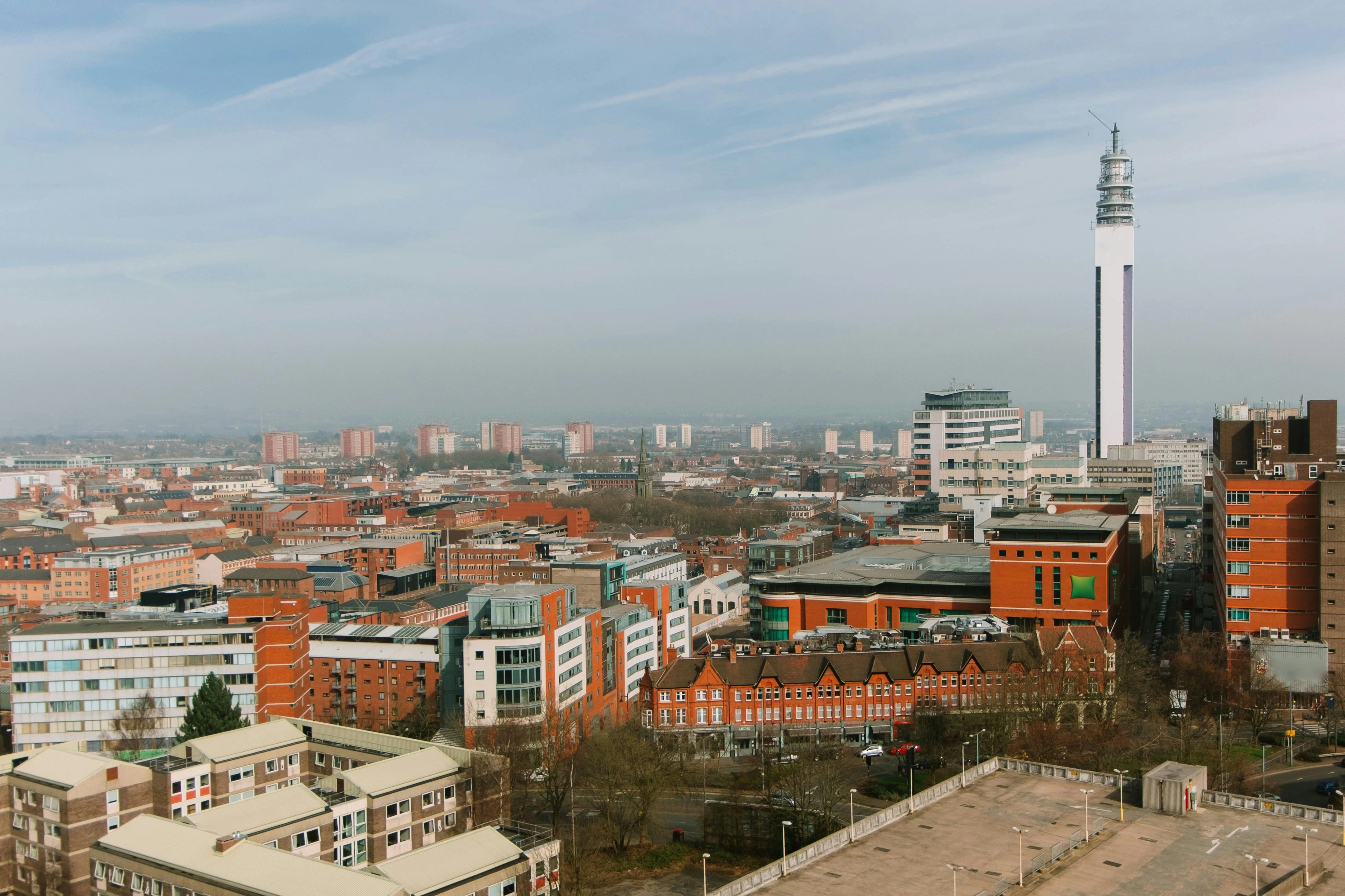 Birmingham street with a red bus, showcasing the vibrant atmosphere and city life, perfect for visitors renting in Birmingham to explore what’s on.